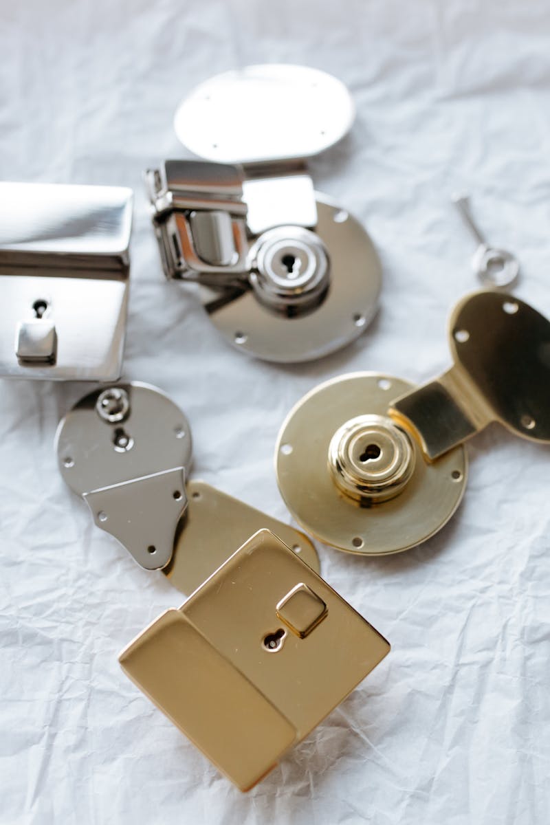 Detailed shot of different metal locks and a key on a textured surface, highlighting security.